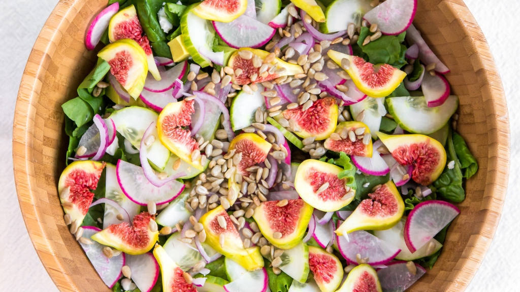 Summer fig salad with figs, radishes, cucumber, red onion, spinach, romaine, sunflower seeds, avocado, and feta cheese